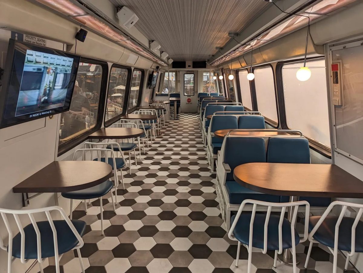 Inside metrobar’s railcar: two-seat tables along one side and four-seat booths along the other